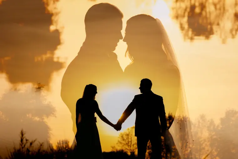 Double exposure of a couple's silhouettes over a golden sunset at Wokefield Park